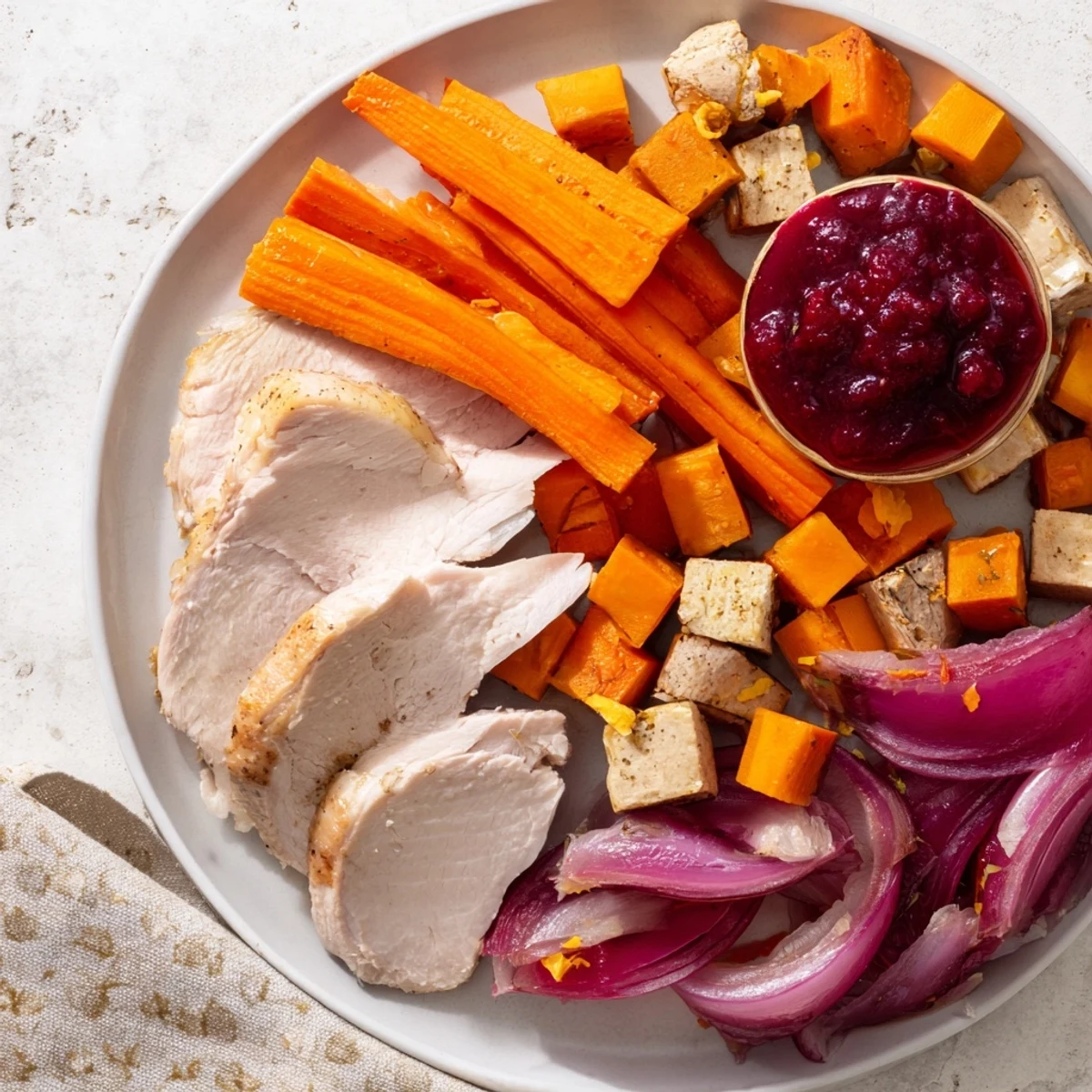 A delicious Harvest Turkey Platter, with slices of turkey and cranberry-orange sauce, ready to serve.