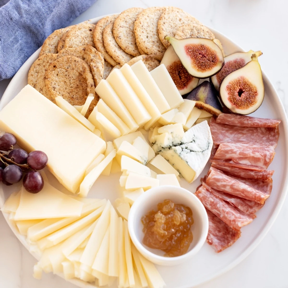 A colorful Wine & Food Pairing Platter, arranged with cheese, charcuterie, and fresh fruits alongside wine glasses.