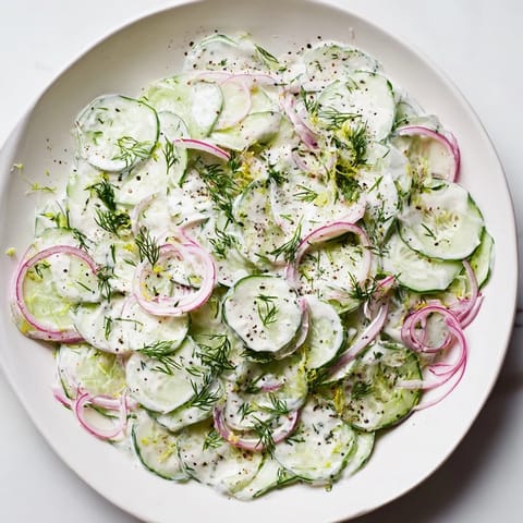 This delicious Cold Cucumber-Dill Salad with Yogurt features vibrant green cucumber slices and herbs.