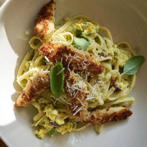 This Pesto Egg and Chicken Pasta shows perfectly cooked chicken and a rich, creamy sauce.