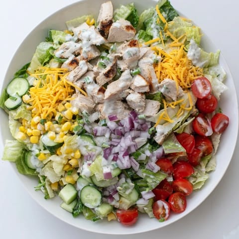 Enjoy this hearty Ranch Chicken Chopped Salad for lunch or dinner, combining juicy tomatoes, crunchy cucumbers, and fresh herbs in every bite.