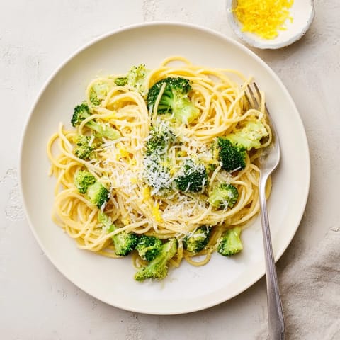 Close-up of One-Pot Lemon Broccoli Pasta in a skillet, bright green broccoli and silky sauce glistening, ready to serve.  